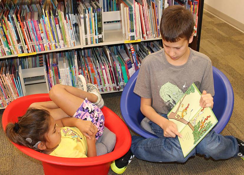 Student reading to another student during library time