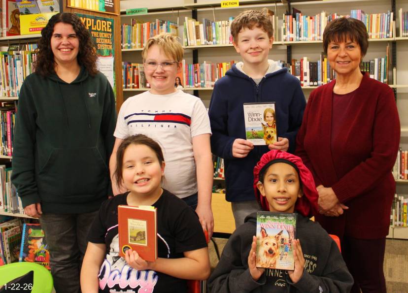 Novel group posing with the book they just finished